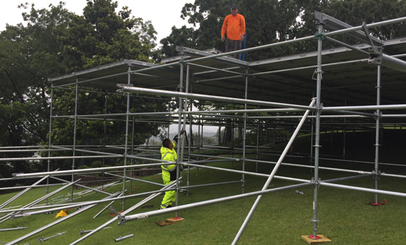 Two men setting up scaffolding