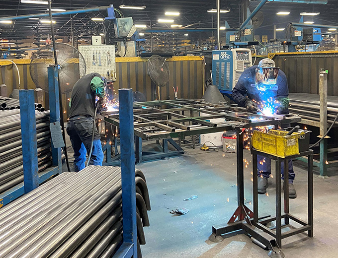 Two men welding frame