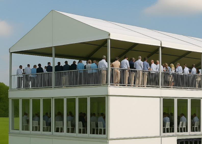 Two-story event pavilion with people gathered on the upper balcony.